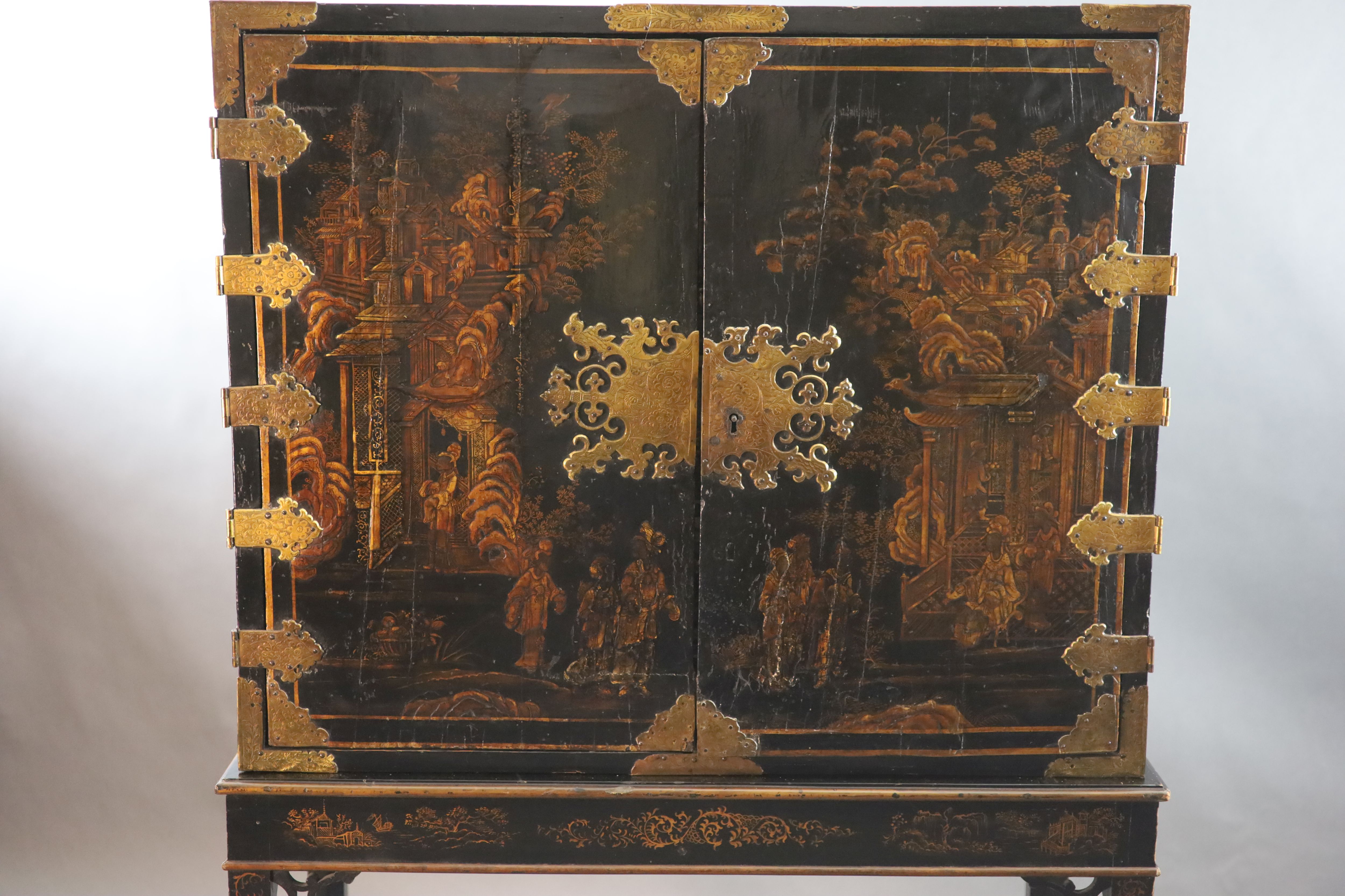 A late 17th century japanned cabinet on later stand W. 3ft. 1in. D. 1ft 4.5in. H. 2ft. 6in. Height overall 6ft 3in.